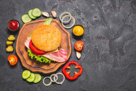 Ingredients for tasty burger on dark backgroundの写真素材