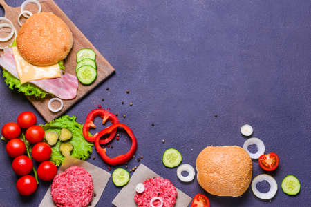 Ingredients for tasty burger on dark backgroundの写真素材