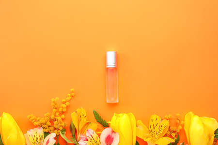 Beautiful composition with perfume bottle on color backgroundの写真素材