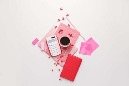 Stationery with cup of coffee on white backgroundの写真素材
