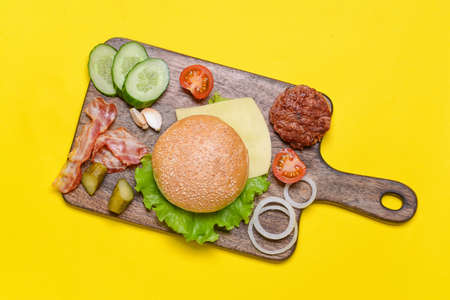 Ingredients for tasty burger on color backgroundの写真素材