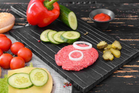 Ingredients for tasty burger on wooden tableの写真素材