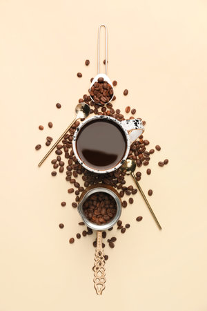 Cup of coffee with roasted beans on color backgroundの写真素材