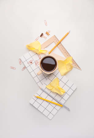 Stationery with cup of coffee on white backgroundの写真素材