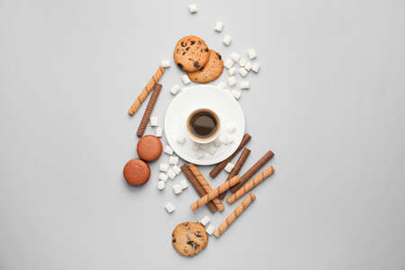 Sweets with cup of coffee on light backgroundの写真素材