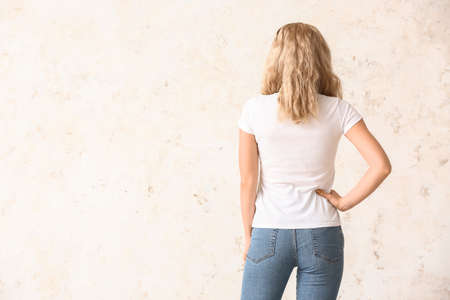 Woman in stylish t-shirt on light backgroundの写真素材