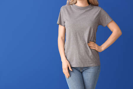 Woman in stylish t-shirt on color backgroundの写真素材