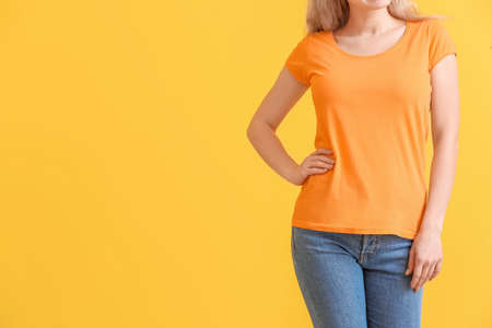 Woman in stylish t-shirt on color backgroundの写真素材
