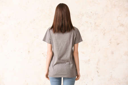 Woman in stylish t-shirt on light backgroundの写真素材
