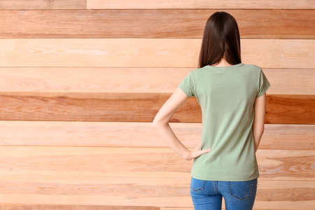 Woman in stylish t-shirt on wooden backgroundの写真素材