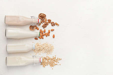 Bottles of different milk on white backgroundの写真素材