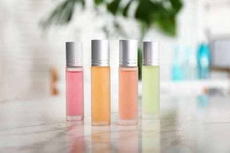Bottles of roll-on perfumes on tableの写真素材