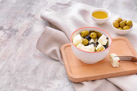 Tasty feta cheese with olives on gray backgroundの写真素材