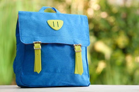 School backpack on table outdoors