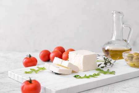 Tasty feta cheese with herbs on white backgroundの写真素材