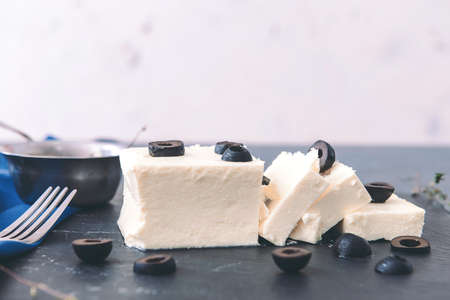 Tasty feta cheese with olives on tableの写真素材