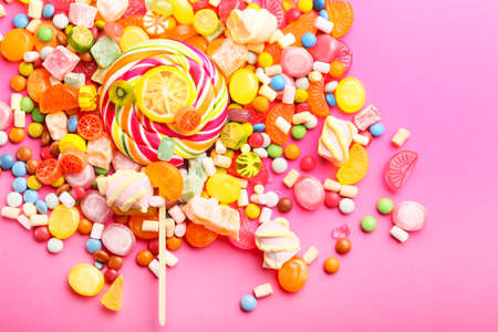 Assortment of sweet candies on color backgroundの写真素材