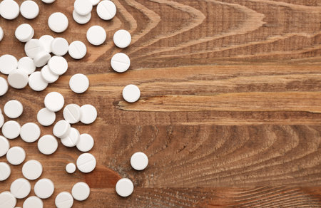 Many pills on wooden backgroundの写真素材