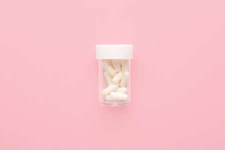 Jar with pills on color backgroundの写真素材
