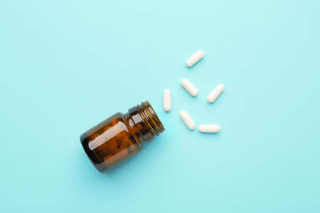 Jar with pills on color backgroundの写真素材