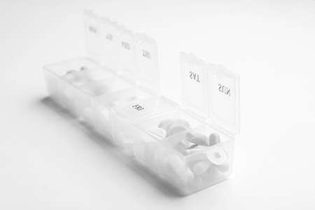 Container with pills on white backgroundの写真素材