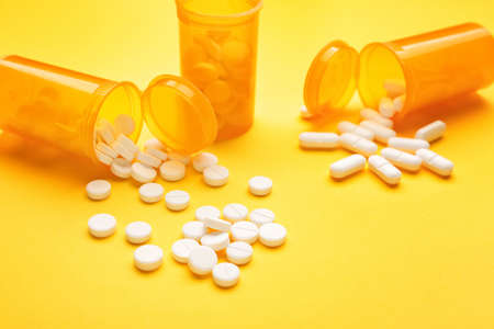 Jars with pills on color backgroundの写真素材
