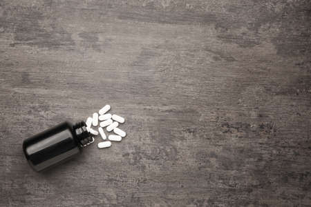 Jar with pills on wooden backgroundの写真素材