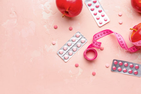 Measuring tape, apples and weight loss pills on color backgroundの写真素材