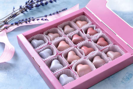 Box with delicious candies on color backgroundの写真素材