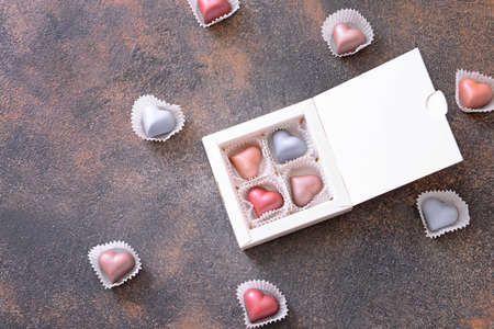 Box with delicious candies on dark background