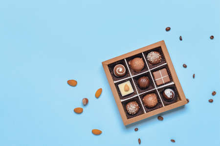 Box with delicious candies on color backgroundの写真素材