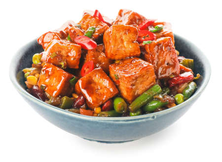 Bowl with tasty tofu cheese and vegetables on white backgroundの写真素材