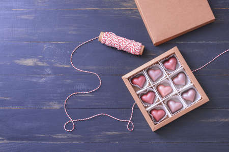 Box with delicious candies on dark wooden backgroundの写真素材