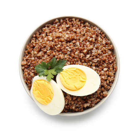 Bowl of tasty buckwheat porridge and eggs on white backgroundの写真素材