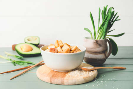 Bowl with tasty tofu cheese on tableの写真素材