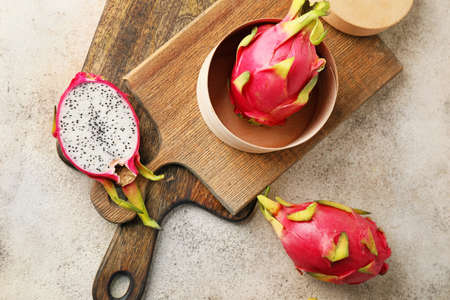 Boards with tasty dragon fruit on gray backgroundの写真素材