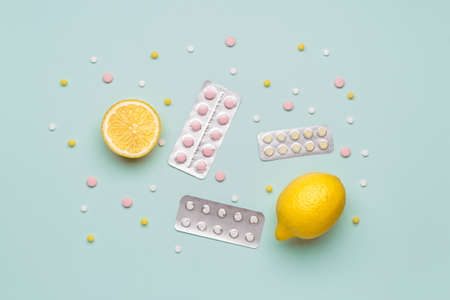 Weight loss pills and lemon on color backgroundの写真素材