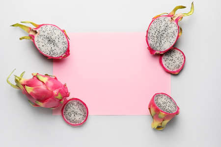 Tasty dragon fruit with paper sheet on gray backgroundの写真素材