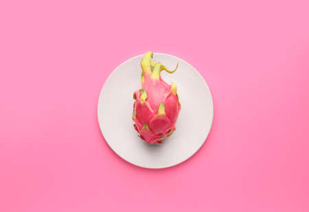 Tasty dragon fruit with plate on color backgroundの写真素材