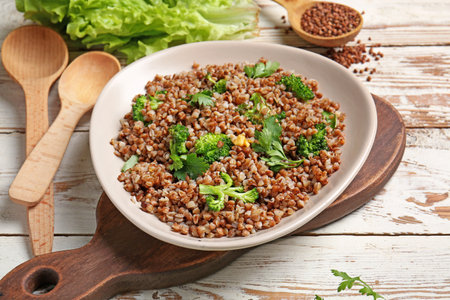 Plate with tasty buckwheat porridge and broccoli on tableの写真素材