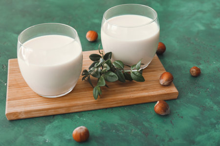Glasses of tasty hazelnut milk on tableの写真素材