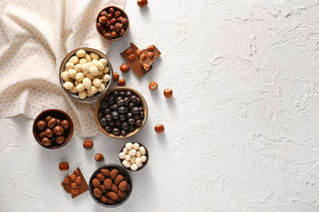 Different tasty chocolate nuts on white backgroundの写真素材