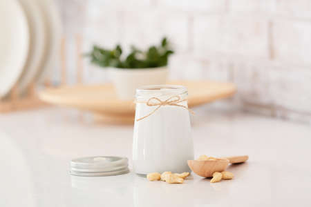 Jar of tasty cashew milk on tableの写真素材