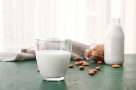 Glass of tasty almond milk on tableの写真素材