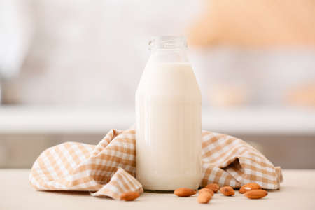 Bottle of tasty almond milk on tableの写真素材