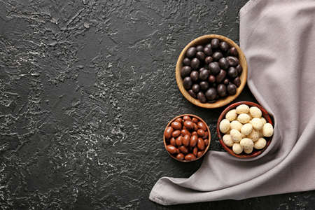 Different tasty chocolate nuts on dark backgroundの写真素材