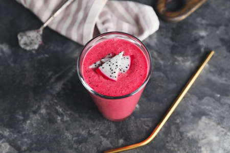 Glass of dragon fruit smoothie on dark backgroundの写真素材