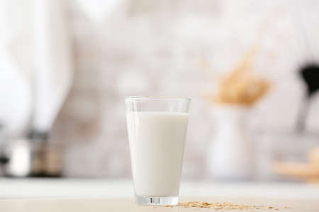 Glass of tasty oat milk on tableの写真素材