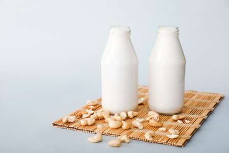Bottles of tasty cashew milk on gray backgroundの写真素材