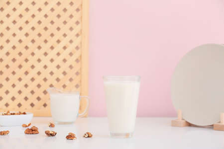 Glass of tasty walnut milk on tableの写真素材